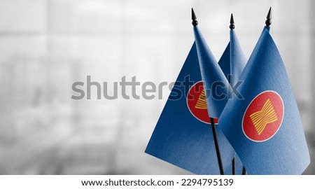 Small flags of the ASEAN on an abstract blurry background. Royalty-Free Stock Photo #2294795139