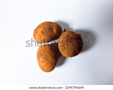 close-up New three raw potatoes isolated on white background
