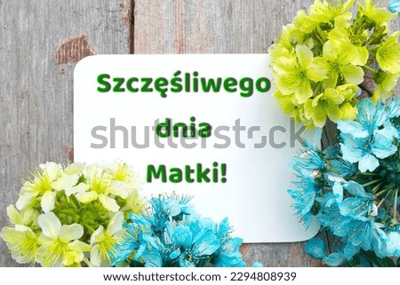 Szczęśliwego dnia Matki it means in Polish Happy Mother's Day. Greeting, wishing card. Happy Mothers day banner. Elegant quote for poster green blue cherry blossom flower on  old wooden background