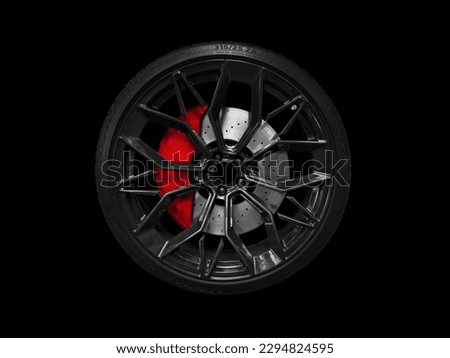 Car alloy wheel and tyre isolated on black background. New alloy wheel with tire and yellow carbon ceramic brakes. Alloy rim isolated. Car wheel disc. Car spare parts.