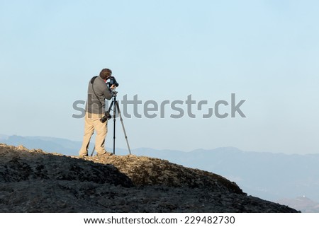 Photographer tacking pictures of the view in Meteora, Greece.