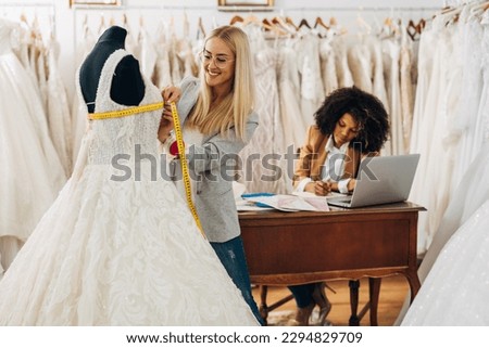 Measuring chest circumference of a dress on a model Royalty-Free Stock Photo #2294829709