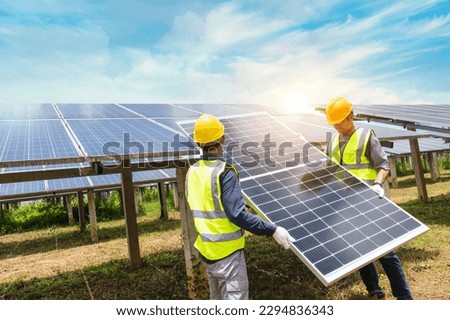 A team of male engineers is about to install solar panels. at the solar power station Engineer team ordered and installed solar cells. Royalty-Free Stock Photo #2294836343