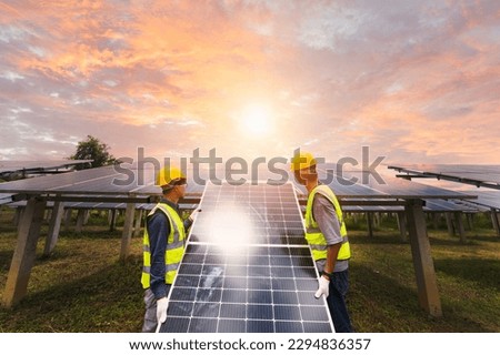 A team of male engineers is about to install solar panels. at the solar power station Engineer team ordered and installed solar cells. Royalty-Free Stock Photo #2294836357