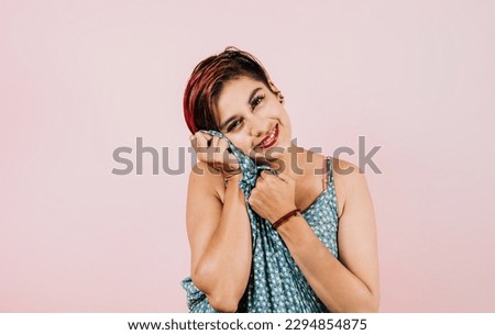 portrait of young latin woman on coral pink background in Mexico Latin America, hispanic female