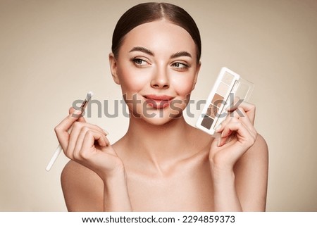 Beauty woman with eye shadow makeup palette. Model with healthy perfect skin, close up portrait. Cosmetology, beauty and spa Royalty-Free Stock Photo #2294859373