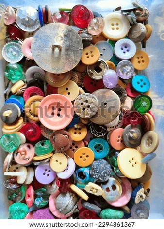 pile of colorful shirt buttons of various sizes Royalty-Free Stock Photo #2294861367