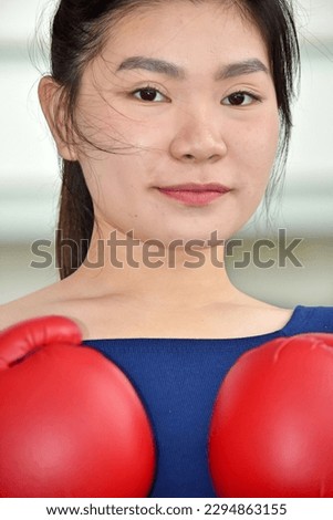 Unemotional Fitness Female Athlete Wearing Boxing Gloves Royalty-Free Stock Photo #2294863155