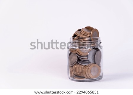 Glass jar filled with indian coins Royalty-Free Stock Photo #2294865851