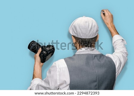 Male teacher explaining how to take good pictures on blue background