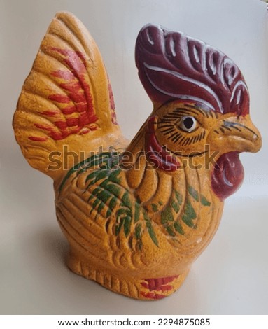 A rooster piggy bank made of clay is a traditional savings account. Usually put at home as well as decoration. 