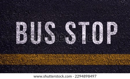 Bus stop text written and yellow line on the road in middle of the asphalt road, Bus stop word on street.
