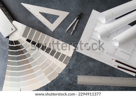 Home floor plans or building blueprint project and open color palette guide catalog with colour swatches. Architect or interior design concept. Choosing paint colors for house, flat or apartment.