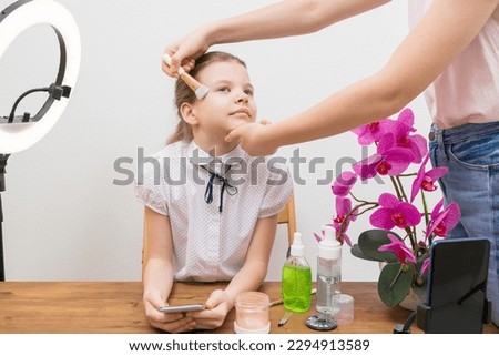 a beautiful young blogger girl is preparing for a reportage to apply makeup