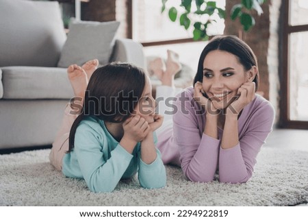 Photo of lovely cute mother little kid with harmony relationship enjoy free time together in modern living room