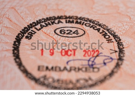 close-up part of page of document, foreign passport for travel with Sri Lanka visa, tourist visa stamp with hologram with shallow depth of field, passport control at border, travel in Southeast Asia