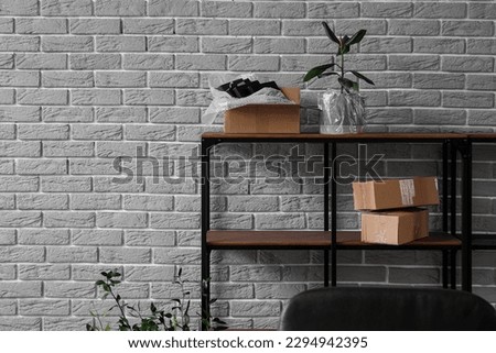 Shelving unit with cardboard boxes in office on moving day
