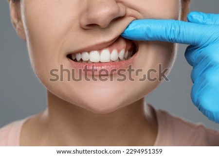 Woman showing healthy gums on gray background, closeup Royalty-Free Stock Photo #2294951359