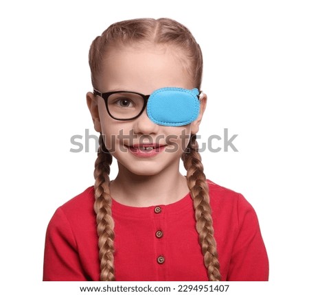 Happy girl with eye patch on glasses against white background. Strabismus treatment Royalty-Free Stock Photo #2294951407