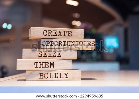 Wooden blocks with words 'Create opportunities, seize them boldly'. Inspirational motivational quote Royalty-Free Stock Photo #2294959635