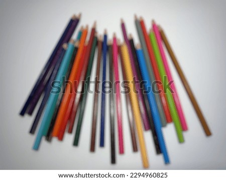 defocused abstract background, multi colored colored pencils