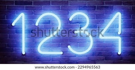 Glowing neon number (1, 2, 3, 4) signs on brick wall Royalty-Free Stock Photo #2294965563