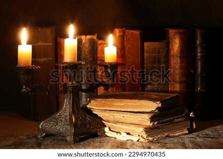 Nice vintage candlestick on background with old books
