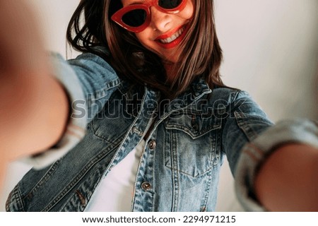 Close up of beautiful woman taking photo with smartphone, selfie.