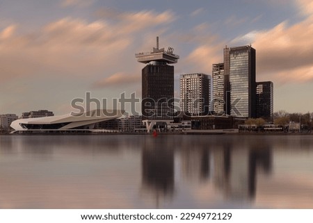 Panoramic landscape about the Amsterdam's skylines included the A'dam lookout tower and Eye Film Museum too. the buildings are reflected on the water. Royalty-Free Stock Photo #2294972129