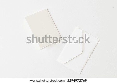 Mock up of a blank white greeting card paper in a isolated solid white background and soft lighting