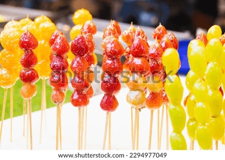 Skewers of sugar coated fruit Royalty-Free Stock Photo #2294977049