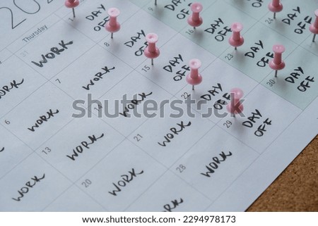 4 day work week printed calendar with pink pins on three days off in week weekend days four day working week concept. Modern approach doing business short workweek. Effectiveness of employees Royalty-Free Stock Photo #2294978173