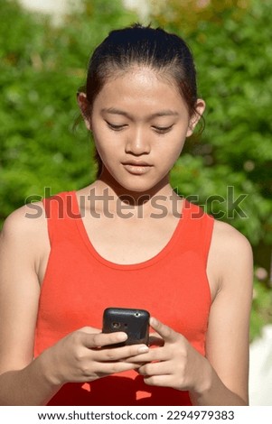 Serious Beautiful Girl With Mobile Phone Royalty-Free Stock Photo #2294979383