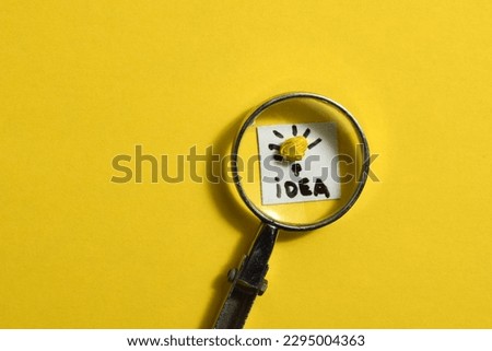 soft focus, Creative idea concept, magnifying glass and light bulb icon with yellow background