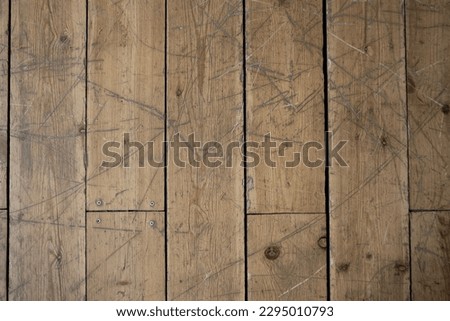 brown wooden floor with scratches and scuffs Royalty-Free Stock Photo #2295010793