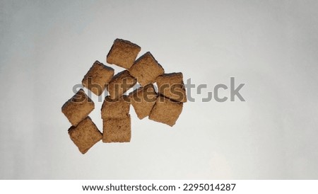 pillow-shaped snack with chocolate filling inside in white background 