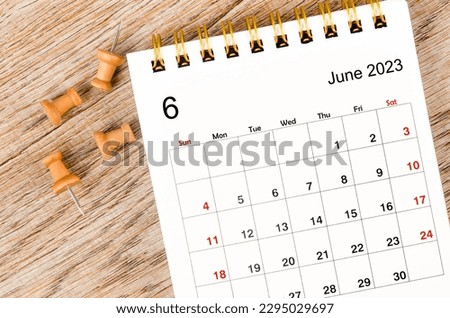 June 2023 Monthly desk calendar for 2023 year with pin on wooden background. Royalty-Free Stock Photo #2295029697