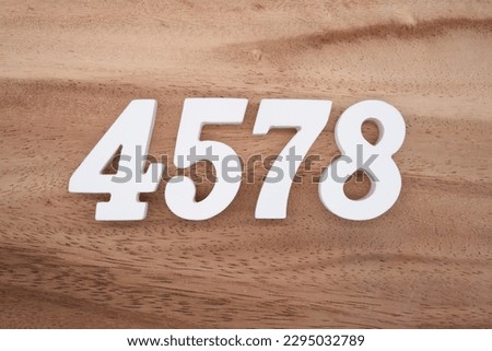 White number 4578 on a brown and light brown wooden background.