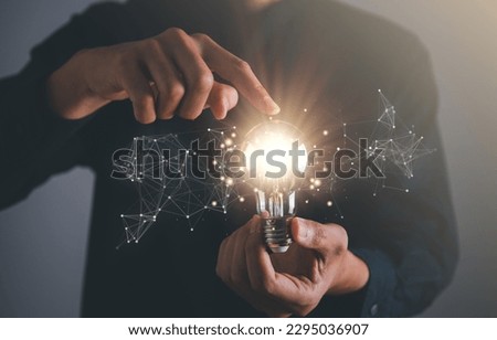 Business man holding light bulb. New idea, innovation technology and creative concept. Royalty-Free Stock Photo #2295036907