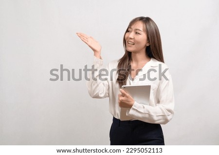 A Young asian businesswoman using tablet over white background, technology concept