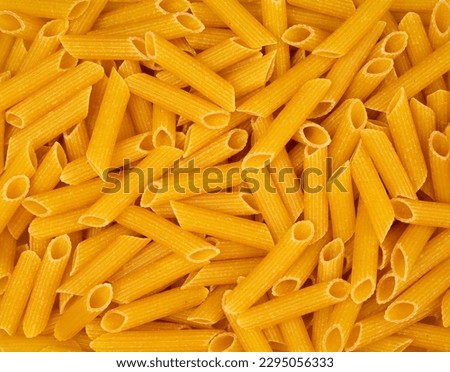 Full frame close up of penne pasta, top view Royalty-Free Stock Photo #2295056333
