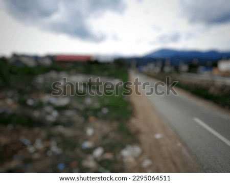 The view on the side of the road is covered with so much plastic trash the blur's background