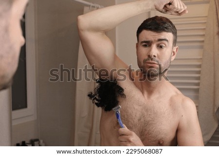 Man with an extremely hairy armpit  Royalty-Free Stock Photo #2295068087