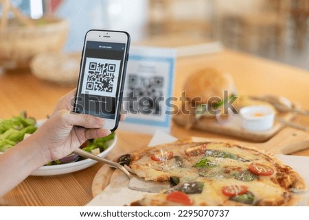 Woman use smartphone to scan QR code to pay in cafe restaurant with a digital payment without cash. Choose menu and order accumulate discount. E wallet, technology, pay online, credit card, bank app. Royalty-Free Stock Photo #2295070737
