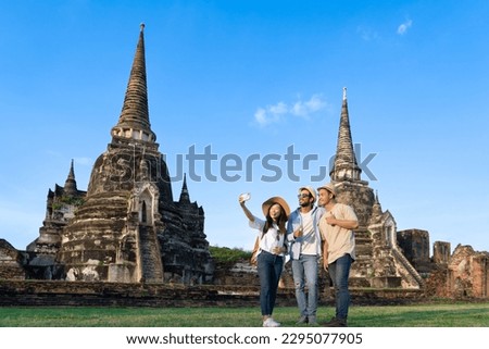 group of friends tourism taking selfie photo or making video call at Wat Phra Si Sanphet in Ayutthaya historical park pagoda temple, UNESCO attractive tourist while traveling on holiday vacation