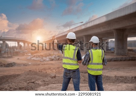 The expressway engineering team inspected the construction work. Asian architects and mature supervisors meeting at the construction site. Workers discuss plans construction workers work together  Royalty-Free Stock Photo #2295081921