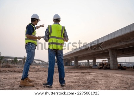 The expressway engineering team inspected the construction work. Asian architects and mature supervisors meeting at the construction site. Workers discuss plans construction workers work together  Royalty-Free Stock Photo #2295081925