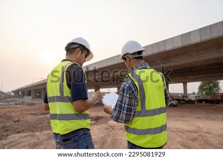 The expressway engineering team inspected the construction work. Asian architects and mature supervisors meeting at the construction site. Workers discuss plans construction workers work together  Royalty-Free Stock Photo #2295081929