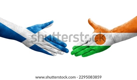 Handshake between Niger and Scotland flags painted on hands, isolated transparent image.