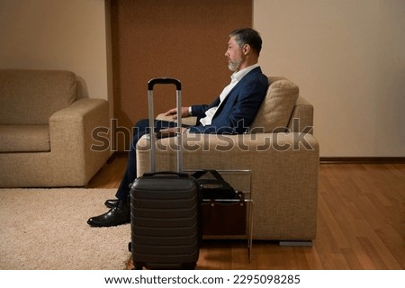 Male sitting in chair in the hotel Royalty-Free Stock Photo #2295098285